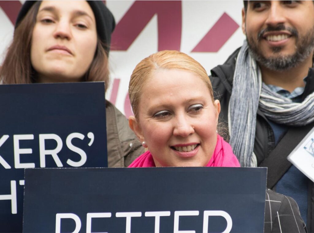 close up of activists holding signs at equal opportunity policy advocacy event