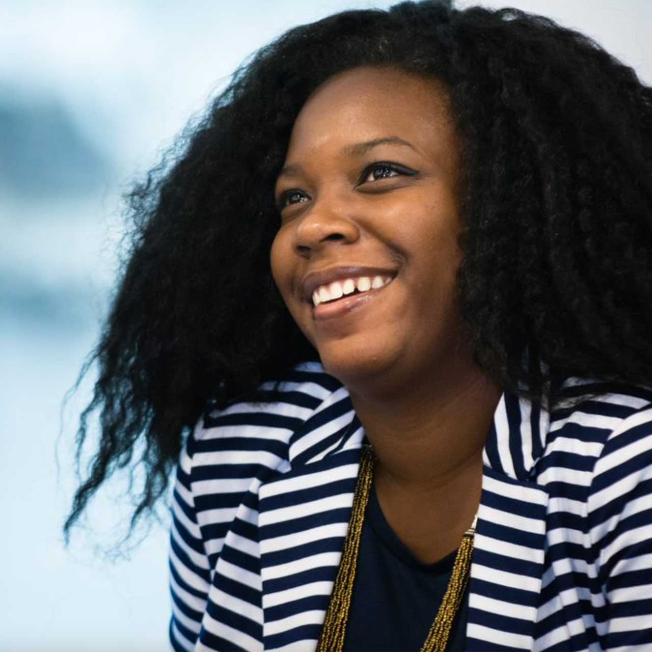 portrait of smiling woman in black and white blazer