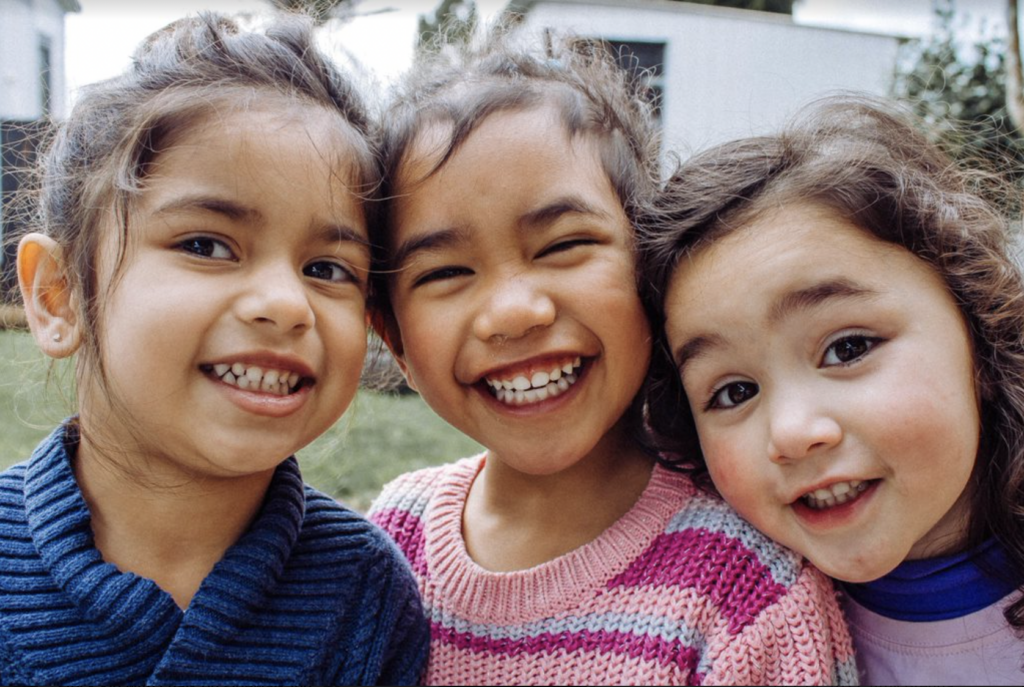 3 young children smiling