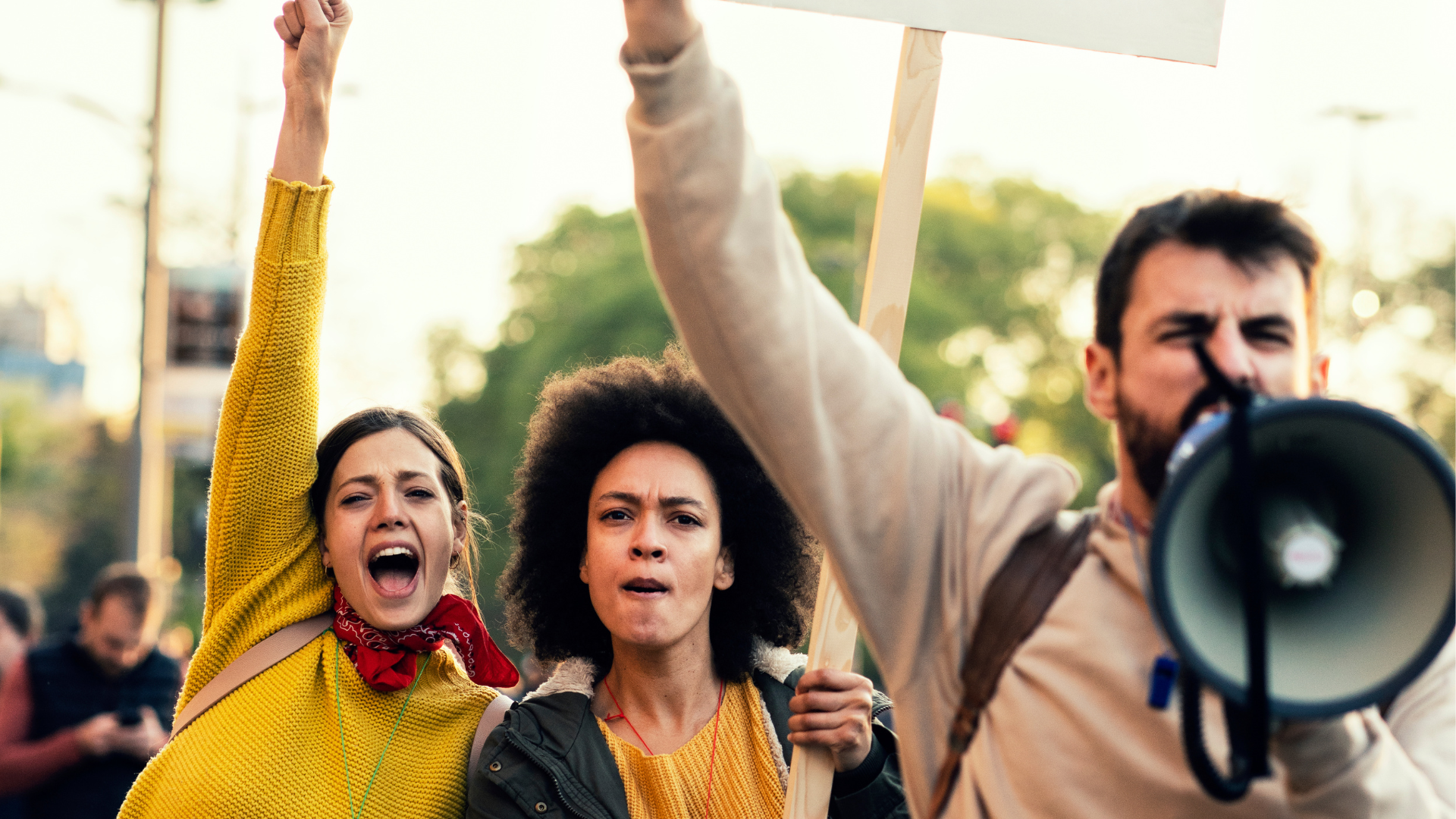 people marching speaking into megaphone