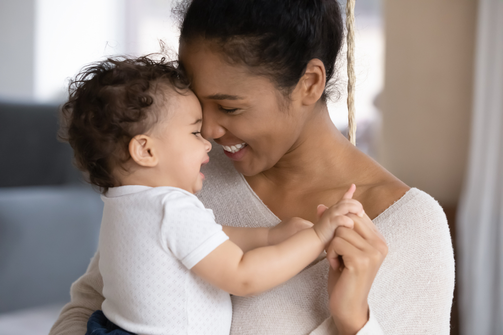 happy young african american mother hugging child